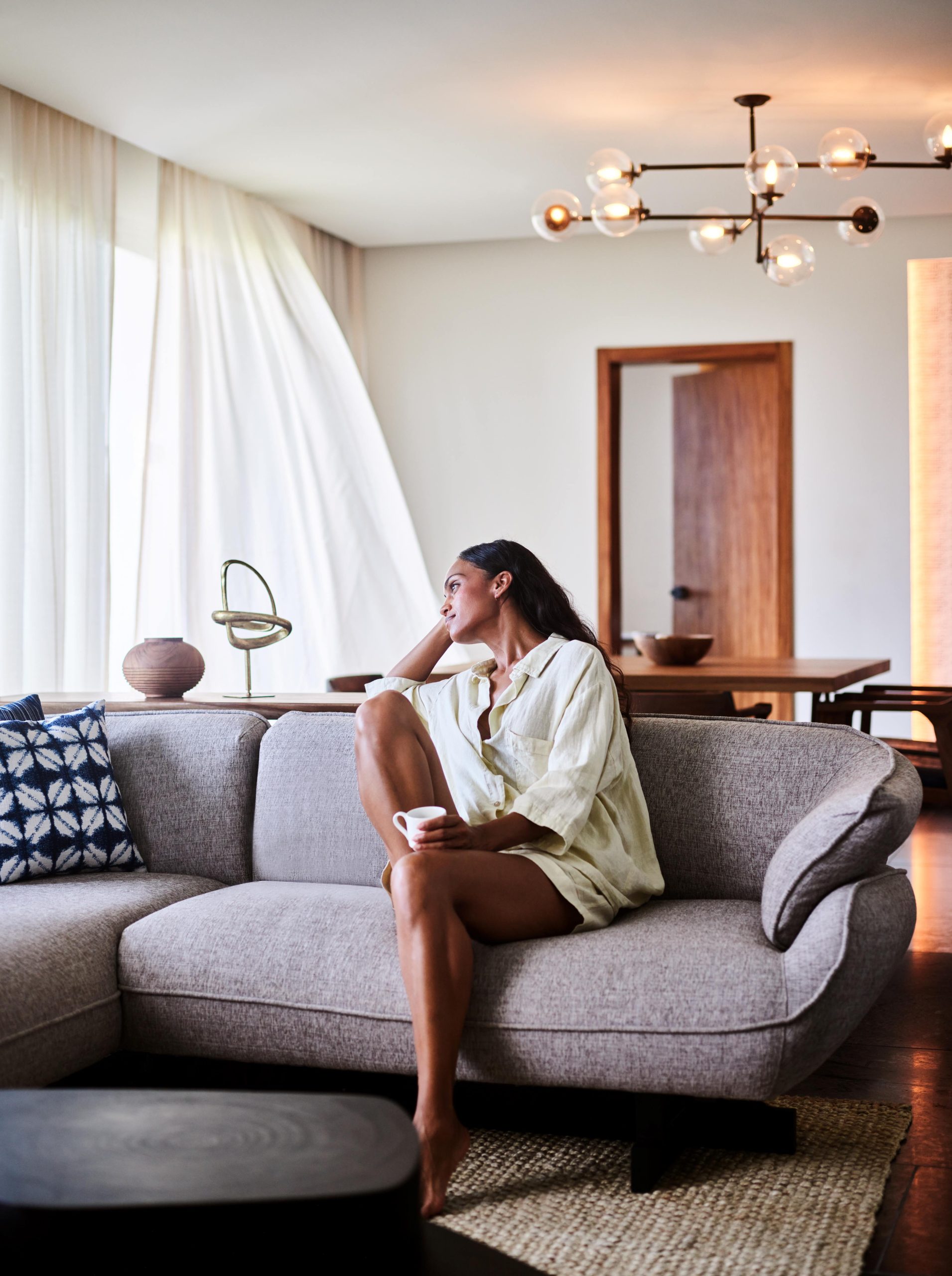 Woman enjoying coffee at a Ceiba Suite, Conrad Tulum Riviera Maya